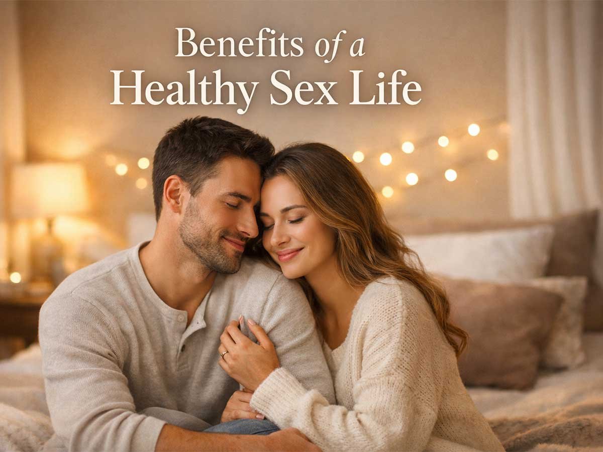 A married couple sitting close on a bed, gently embracing and smiling in a warm, cozy bedroom setting.