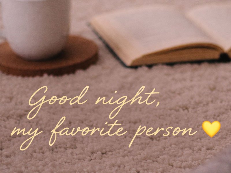 Text reading “Good night, my favorite person” over a cozy background with a book and warm drink.