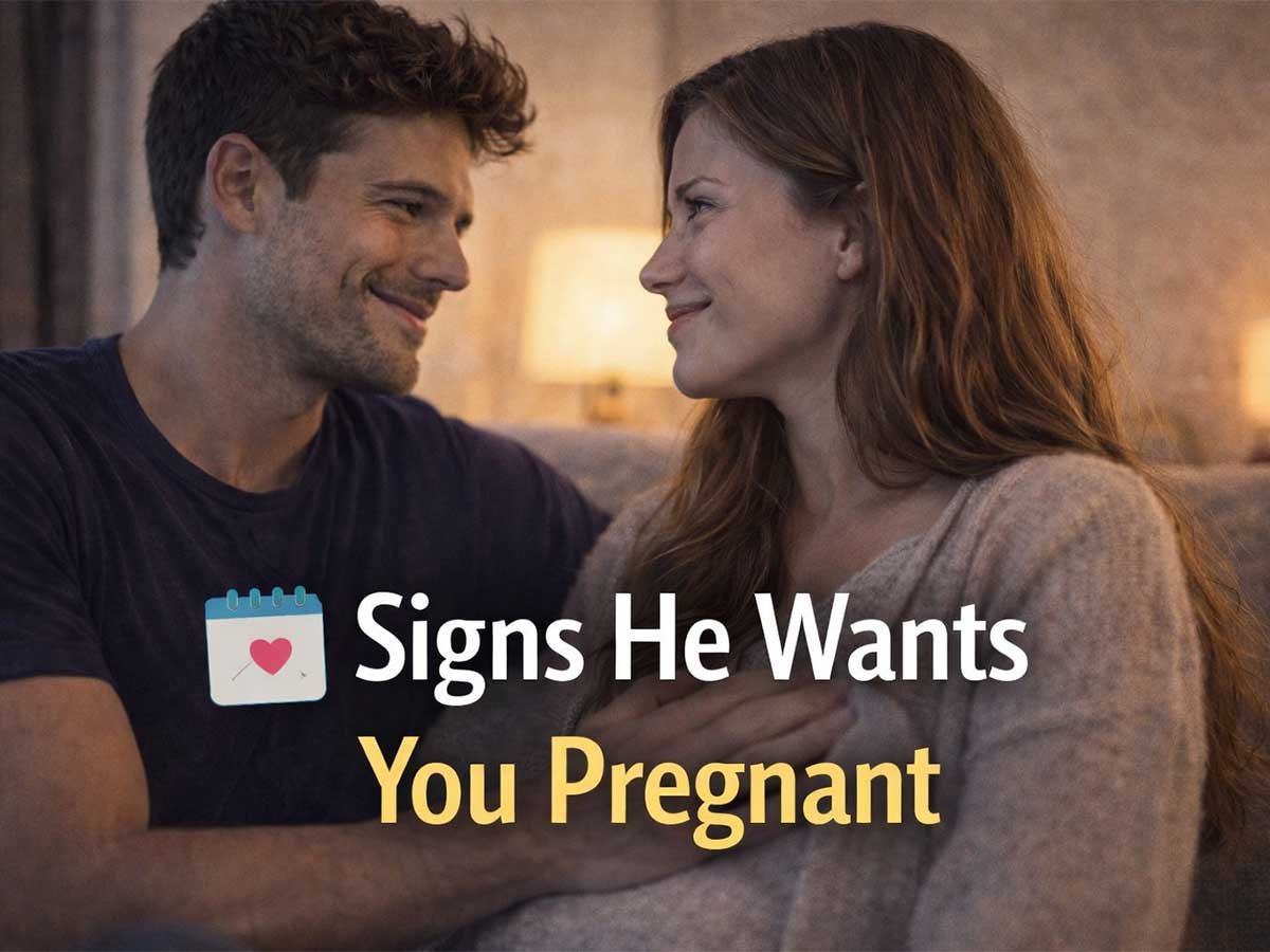 Couple sitting close on a couch, smiling at each other, with text reading “Signs He Wants You Pregnant.”