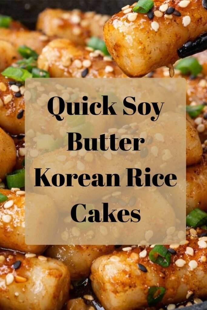 Quick soy butter Korean rice cakes garnished with sesame seeds and green onions in a skillet