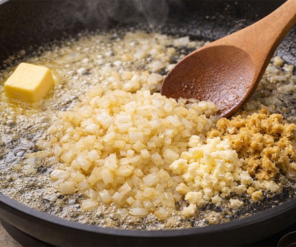 Melt butter, cook the onions until soft, then stir in garlic and ginger for a quick burst of flavor.
