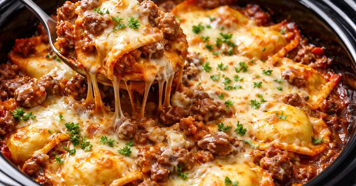 Cheesy crockpot ravioli lasagna with meat sauce being lifted on a spoon