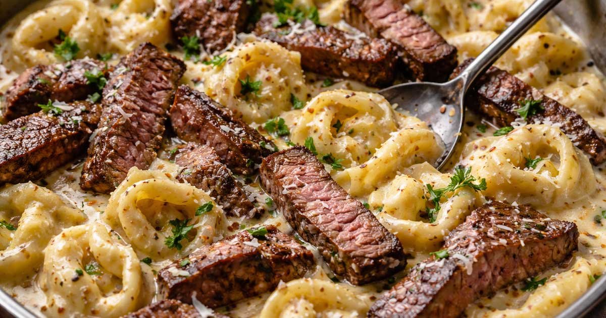 Creamy garlic steak tortellini with sliced steak in rich parmesan sauce.