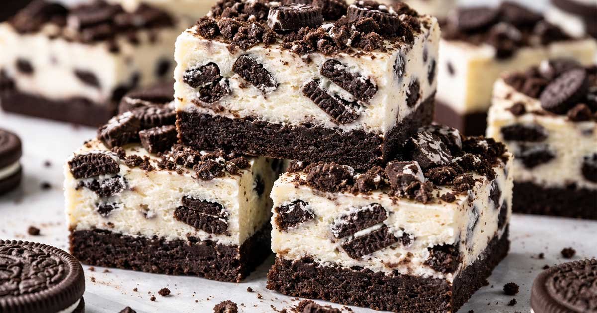 Keto Oreo cheesecake bars with chocolate crust and creamy filling topped with cookie crumbs.