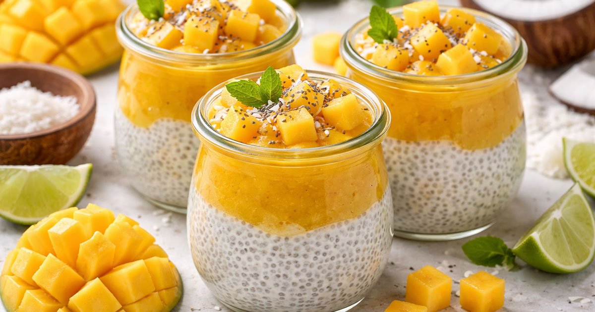 Mango coconut chia pudding in glass jars topped with fresh mango cubes and chia seeds.